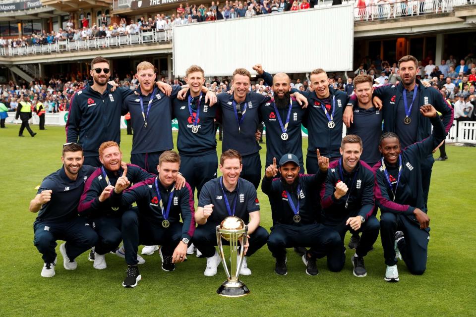 England's World Cup winning cricketers celebrate with their trophy (REUTERS)