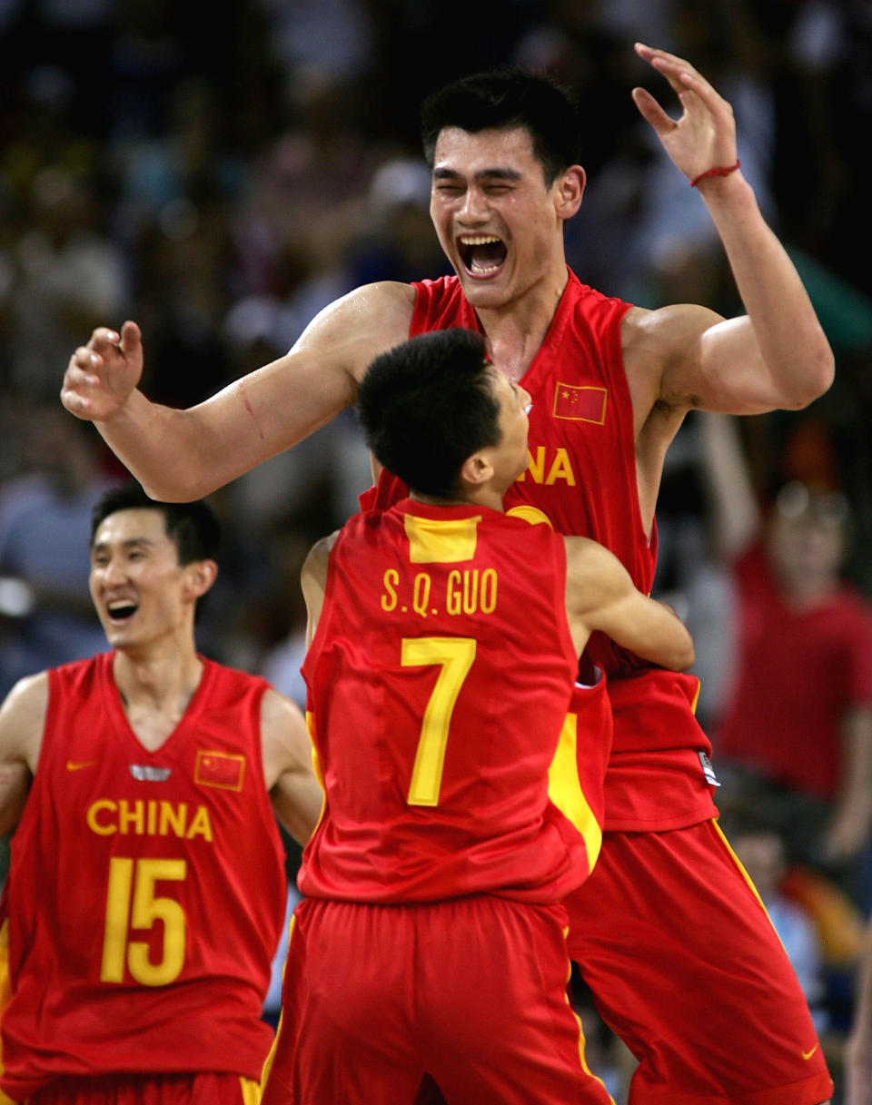 ATHENS - AUGUST 23: Yao Ming #13 and Shiqiang Guo #7 of China celebrate their 67-66 win over Serbia & Montenegro in the men's basketball preliminary game on August 23, 2004 during the Athens 2004 Summer Olympic Games at the Indoor Arena of the Helliniko Olympic Complex in Athens, Greece. (Photo by Stuart Hannagan/Getty Images)