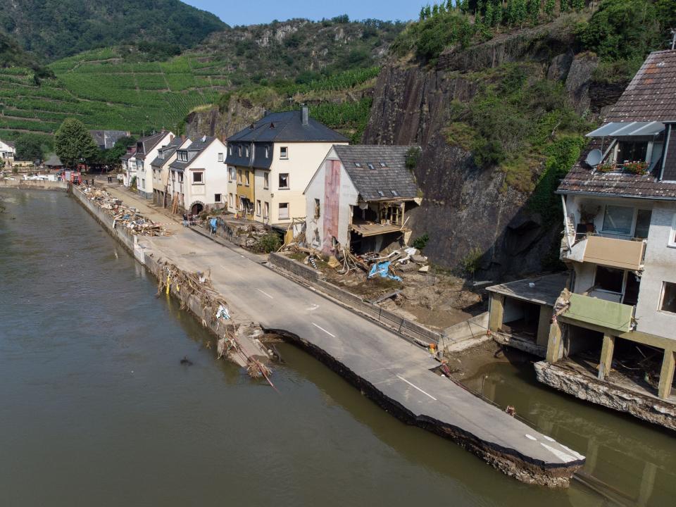 A roadway is surrounded by flood waters and torn apart after extreme weather hit Germany.