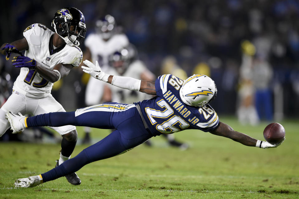 Los Angeles Chargers cornerback Casey Hayward tries to intercept a pass intended for Baltimore Ravens wide receiver John Brown during the second half in an NFL football game Saturday, Dec. 22, 2018, in Carson, Calif. (AP Photo/Kelvin Kuo)