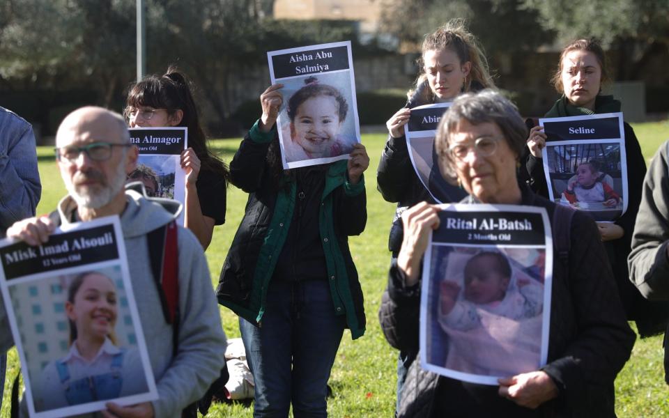 Mandatory Credit: Photo by ABIR SULTAN/EPA-EFE/Shutterstock (14269183o) Israelis hold pictures of Palestinian victims who died during the Israeli-Hamas conflict as they call for a ceasefire outside the US consulate in central Jerusalem, 22 December 2023. More than 19,600 Palestinians and at least 1,200 Israelis have been killed, according to the Palestinian Health Ministry and the Israel Defense Forces (IDF), since Hamas militants launched an attack against Israel from the Gaza Strip on 07 October, and the Israeli operations in Gaza and the West Bank which followed it. Israelis hold vigil for Palestinian victims outside the US consulate in Jerusalem - 22 Dec 2023