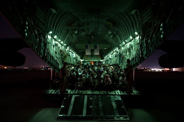In this handout provided by the U.S. Air Force, refugees are seen aboard a C-17 Globemaster III on Aug. 21. in Kabul. Thousands are being flown out daily. (Photo: Handout via Getty Images)