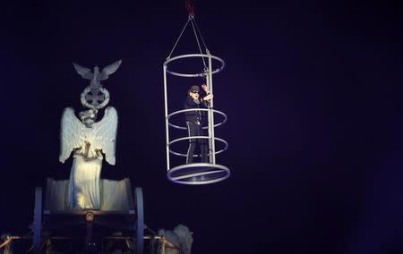 German rock musician Udo Lindenberg performs in a raised cage front of the Brandenburg Gate in Berlin, November 9, 2014. REUTERS/Fabrizio Bensch