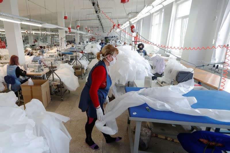 An employee checks a protective suit at the Textile-Contact company's factory in Chernihiv