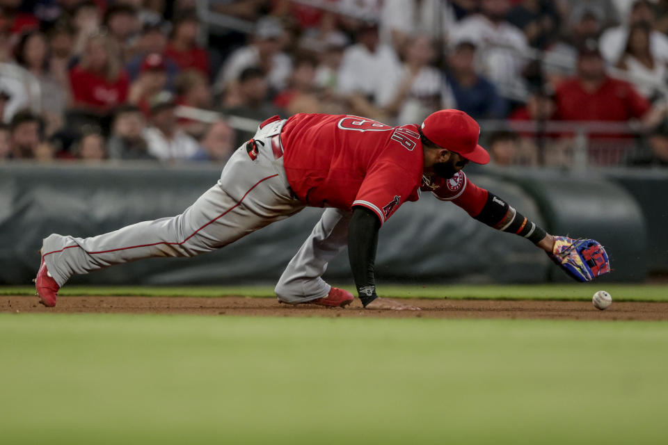 Los Angeles Angels third baseman Jonathan Villar bobbles the ball hit by Atlanta Braves' Dansby Swanson during the fourth inning of a baseball game Saturday, July 23, 2022, in Atlanta. (AP Photo/Butch Dill)