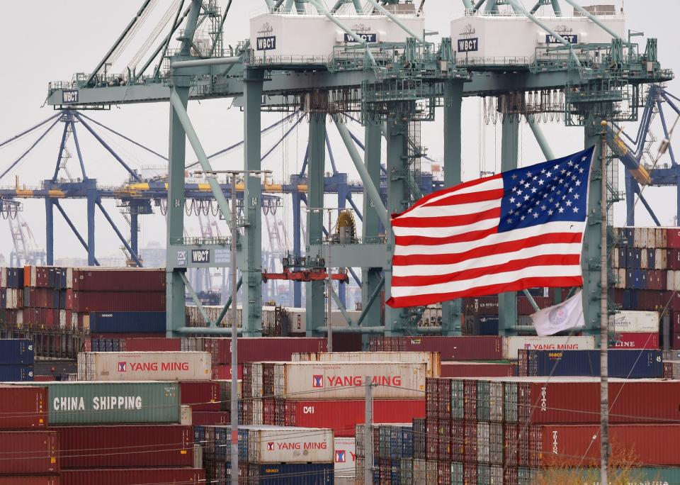 Chinese shipping containers are stored beside a US flag after they were unloaded at the Port of Los Angeles in Long Beach, California on May 14, 2019. - Global markets remain on red alert over a trade war between the two superpowers China and the US, that most observers warn could shatter global economic growth, and hurt demand for commodities like oil. (Photo by Mark RALSTON / AFP)        (Photo credit should read MARK RALSTON/AFP/Getty Images)