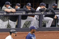 New York Yankees left fielder Jay Bruce rests his head on the dugout railing after he announced his retirement during the seventh inning of the Yankees' loss to the Tampa Bay Rays in a baseball game, Sunday, April 18, 2021, at Yankee Stadium in New York. From left are injured Yankee's first baseman Luke Voit, Yankees outfielder Brett Gardner, Bruce, Yankees outfielder Clint Frazier, and a Yankees coach. (AP Photo/Kathy Willens)