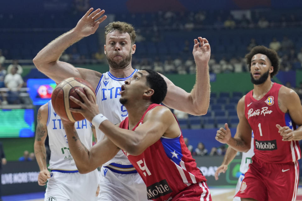 Puerto Rico guard Tremont Waters (51) shoots against Italy forward Nicolo Melli (9) during their Basketball World Cup second round match at the Araneta Coliseum, Manila, Philippines on Sunday Sept. 3, 2023. (AP Photo/Aaron Favila)