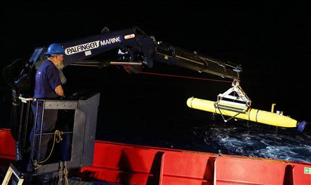 Evan Tanner uses a crane to lift the Phoenix International Autonomous Underwater Vehicle (AUV) Artemis, also known as the Bluefin-21, back onto the Australian Defence Vessel Ocean Shield after searching for missing Malaysia Airlines Flight MH370 in the Southern Indian Ocean in this undated picture released on April 21, 2014 by the Australian Defence Force. REUTERS/Australian Defence Force/Handout via Reuters