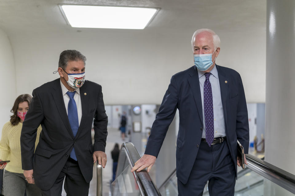 Sen. Joe Manchin, D-W.Va., left, and Sen. John Cornyn, R-Texas, head to the chamber as the Senate steers toward a voting marathon on the Democrats' $1.9 trillion COVID-19 relief bill that's expected to end with the chamber's approval of the measure, at the Capitol in Washington, Friday, March 5, 2021. (AP Photo/J. Scott Applewhite)