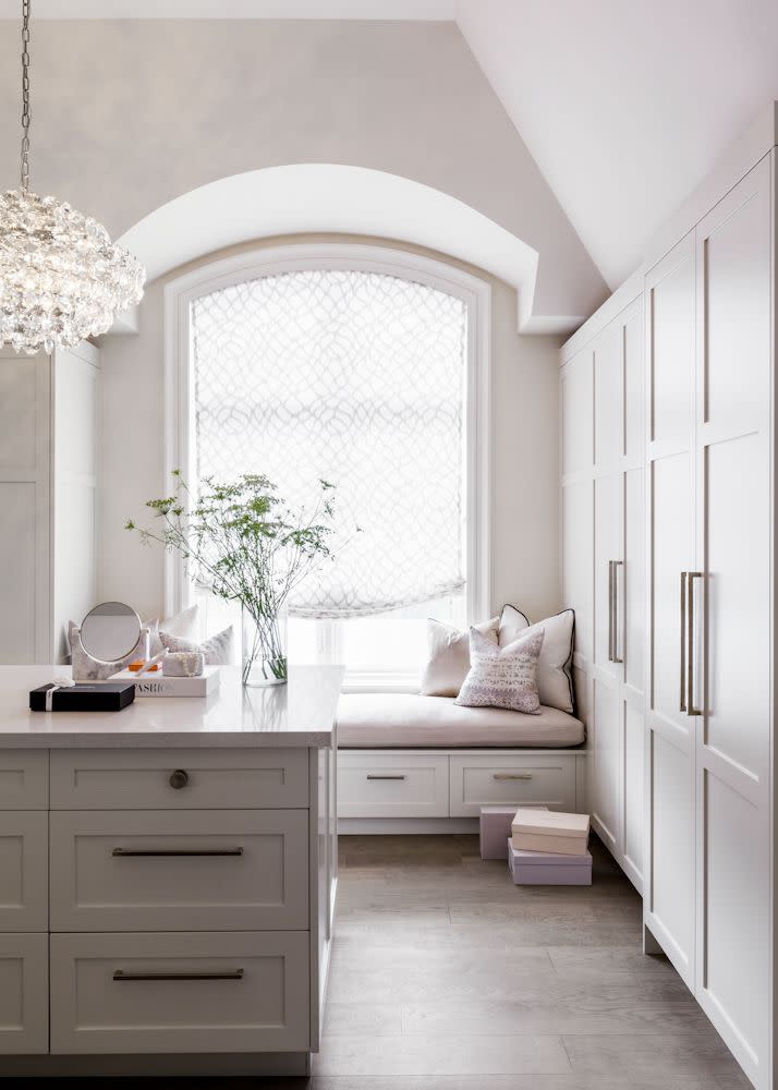 A walk-in closet with comfortable seating