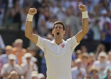 Jul 4, 2014; London, United Kingdom; Novak Djokovic (SRB) celebrates recording match point in his match against Grigor Dimitrov (BUL) on day 11 of the 2014 Wimbledon Championships at the All England Lawn and Tennis Club. Mandatory Credit: Susan Mullane-USA TODAY Sports