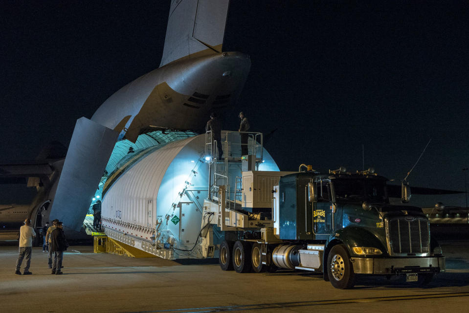 The Space Telescope Transporter for Air, Road and Sea, a specially designed shipping container that held the optical telescope and integrated science instrument module of NASA's James Webb Space Telescope, is unloaded from a U.S. military C-5 Charlie aircraft at Los Angeles International Airport on Feb. 2, 2018. <cite>NASA</cite>