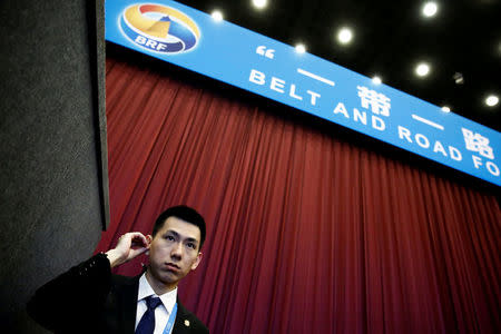 FILE PHOTO - A security guard stands at the entrance to the opening ceremony of the Belt and Road Forum in Beijing, China, May 14, 2017. REUTERS/Thomas Peter/File Photo