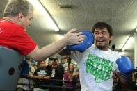 Manny Pacquiao (R) working out with his trainer Freddie Roach on April 2, 2014 in Hollywood