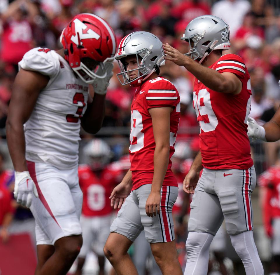 Ohio State kicker Jayden Fielding and punter Jesse Mirco, right, walk off the field following an extra point against Youngstown State.