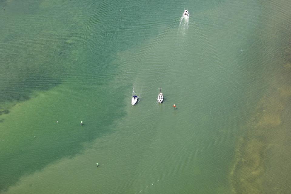 Red tide is observed at Clearwater Beach, Fla., during a flight with SouthWings volunteers on Friday, March 10, 2023. Florida's southwest coast experienced a flare-up of the toxic red tide algae this week, setting off concerns that it could continue to stick around for a while. The current bloom started in October. (Douglas R. Clifford/Tampa Bay Times via AP)