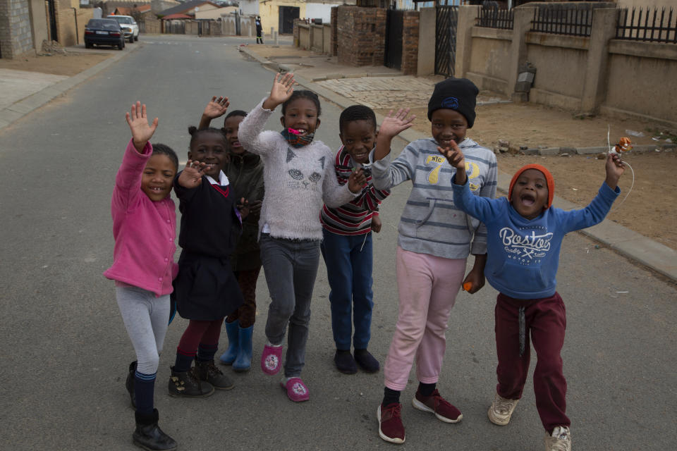Children pose for a photo near the home of Gosiame Thamara Sithole in Tembisa, near Johannesburg, Thursday, June 10, 2021. South Africa is gripped by a mystery over if the woman, Sithole, has, as has been claimed, given birth to 10 babies in what would be a world-first case of decuplets. The South African government said Thursday it is still trying to verify the claim. (AP Photo/Denis Farrell)
