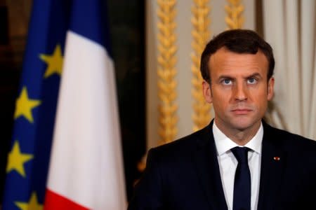 FILE PHOTO: French President Emmanuel Macron attends a news conference at the Elysee Palace in Paris, France December 10, 2017. REUTERS/Philippe Wojazer