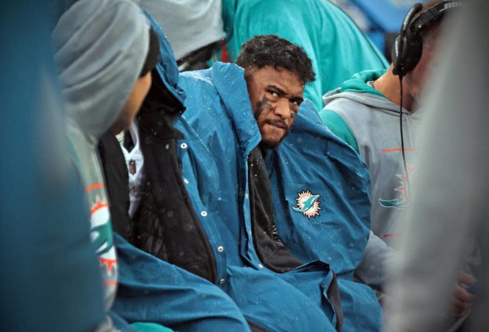Miami Dolphins quarterback Tua Tagovailoa (1) sits on the bench as the Tennessee Titans lead in the fourth quarter at Nissan Stadium in Nashville, Tennessee on Sunday, January 2, 2022.