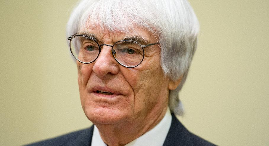 Formula One boss Bernie Ecclestone waits for the beginning of his trial after arriving in the regional court in in Munich, Germany, Thursday, April 24, 2014. Ecclestone is charged with bribery and incitement to breach of trust "in an especially grave case" over a US$ 44 million payment to a German banker, that prosecutors allege was meant to facilitate the sale of the Formula One Group to a buyer of Ecclestone's liking. (AP Photo/Sven Hoppe, pool)