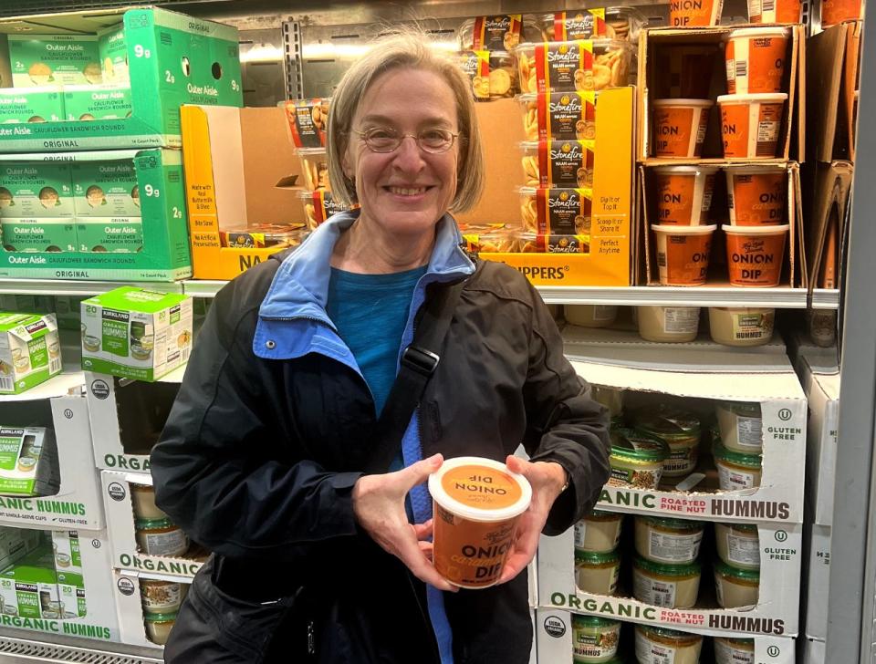 Susan Schwartz holding the Costco's carmelized onion dip, sold for $8.89.