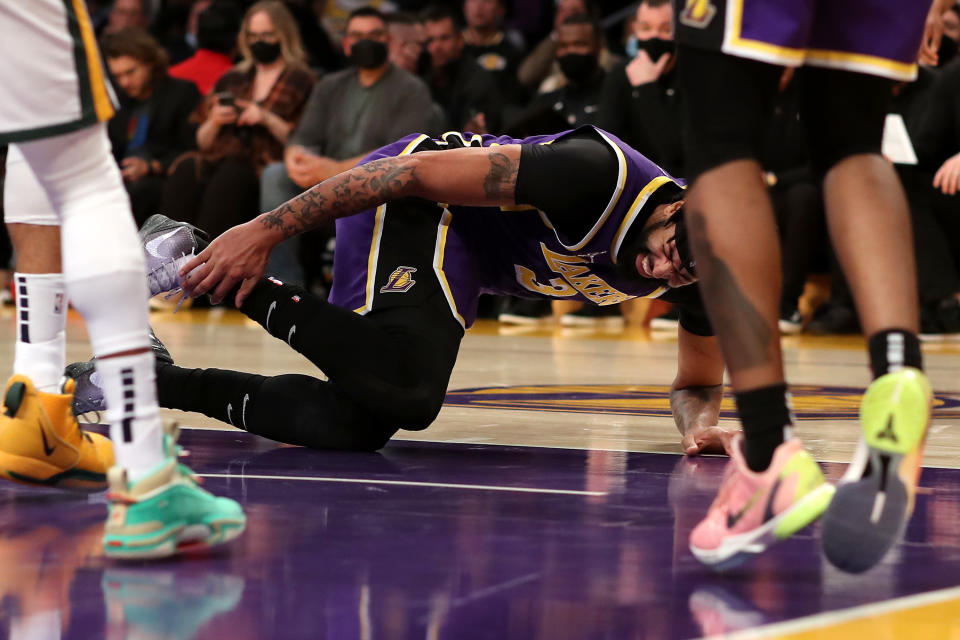 LOS ANGELES, CALIFORNIA - FEBRUARY 16: Anthony Davis #3 of the Los Angeles Lakers holds his ankle after an injury during the second quarter against the Utah Jazz at Crypto.com Arena on February 16, 2022 in Los Angeles, California. NOTE TO USER: User expressly acknowledges and agrees that, by downloading and or using this Photograph, user is consenting to the terms and conditions of the Getty Images License Agreement. (Photo by Katelyn Mulcahy/Getty Images)