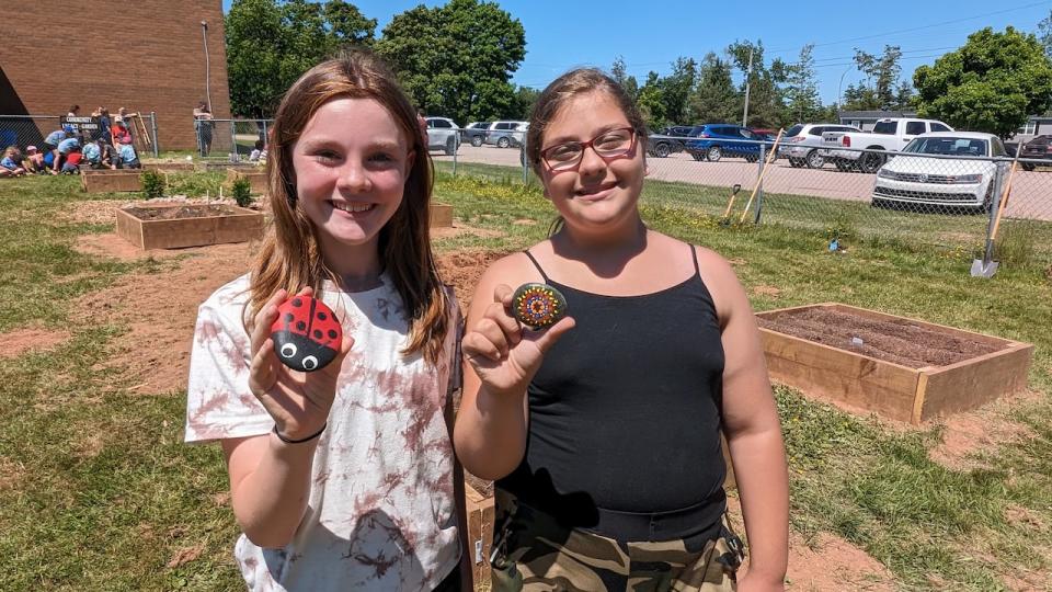 All of the students painted a rock to line one of the gardens. 