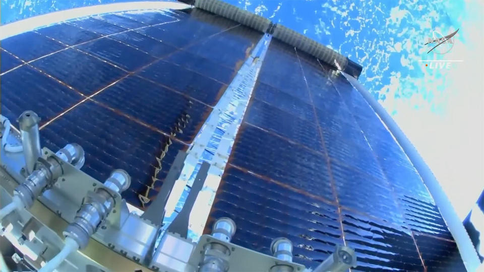 A camera on spacewalker Woody Hoburg's helmet shows the newly installed roll-out solar array — iROSA — unwinding like a window shade after a problem-free installation on the outboard end of the International Space Station's main power truss. It was the sixth iROSA installed to date in a major upgrade of the lab's aging power system. / Credit: NASA