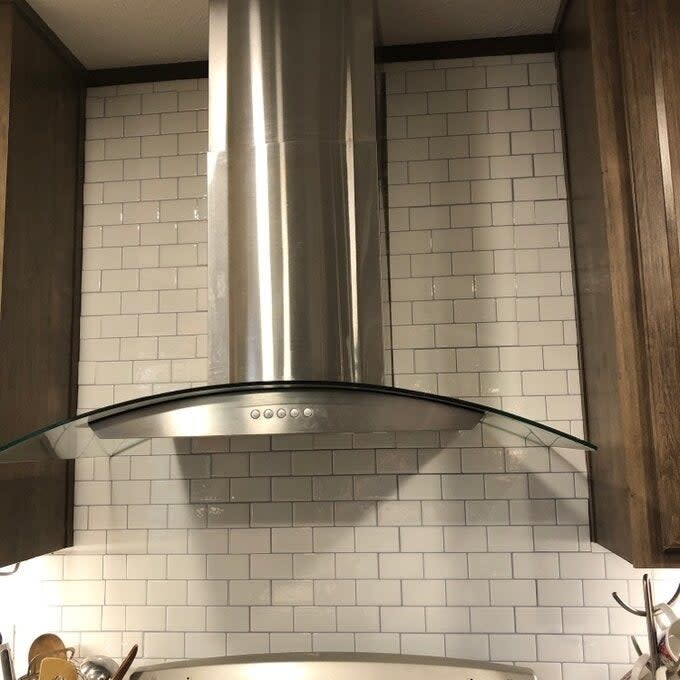 a reviewer photo of the white subway tile backsplash