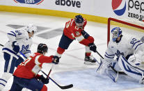 Florida Panthers center Sam Reinhart (13) scores the game-wining goal against Toronto Maple Leafs goaltender Joseph Woll (60) during overtime of Game 3 of an NHL hockey Stanley Cup second-round playoff series, Sunday, May 7, 2023, in Sunrise, Fla. (AP Photo/Michael Laughlin)
