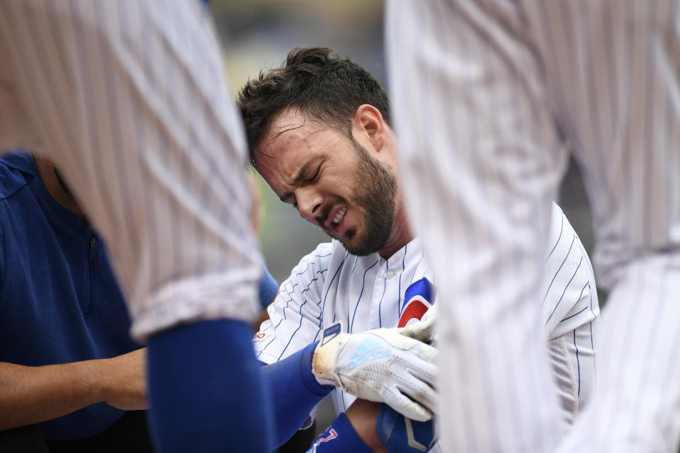 Chicago Cubs' Kris Bryant reacts after getting hurt while sliding into first base during the third inning of a baseball game against the St. Louis Cardinals, Sunday, Sept. 22, 2019, in Chicago. (AP Photo/Paul Beaty)