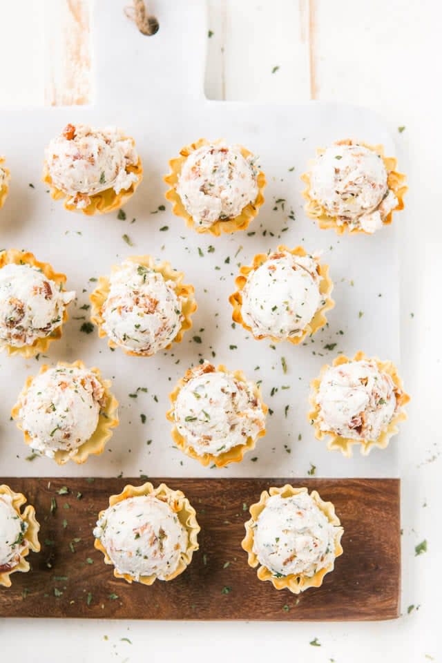 <p>If you need an easy and quick app, you can't go wrong with these phyllo bites. They only take 20 minutes to whip up, and the results are drool-worthy. This recipe will provide you with 30 servings, so just cut the recipe into thirds if you want to feed two people.</p> <p><strong>Get the recipe:</strong> <a href="https://www.azestybite.com/honey-bacon-goat-cheese-phyllo-bites/" class="link rapid-noclick-resp" rel="nofollow noopener" target="_blank" data-ylk="slk:honey bacon goat cheese phyllo bites">honey bacon goat cheese phyllo bites</a></p>