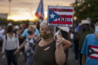 People march along Las Americas Highway to protest the LUMA Energy company in San Juan, Puerto Rico, Friday, Oct. 15, 2021. Ever since LUMA began providing service over the summer, hundreds of thousands of Puerto Ricans have had to deal with widespread blackouts for extended periods of time, voltage fluctuations and bad customer service along with an increase in pricing. (AP Photo/Carlos Giusti)