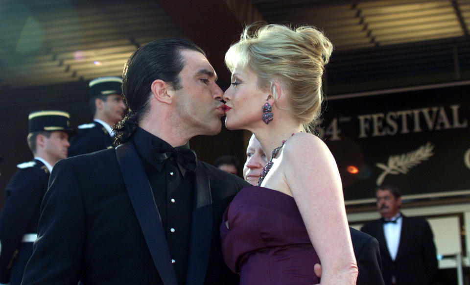 American actress Melanie Griffith (R) kisses her husband Spanish actor Antonio Banderas (L) during a red carpet arrival in a special tribute to her career at the 54th International Cannes Film Festival, May 19, 2001. [Griffith appeared in "Working Girl" by director Mike Nichols and "The Milagro Beanfield War" directed by Robert Redford. ]