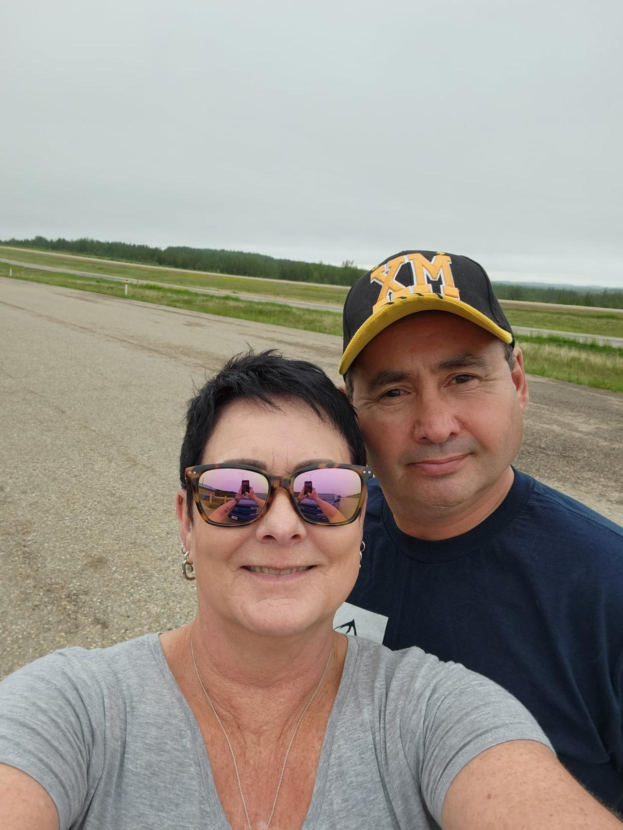 Sue Clarke, left, and Tom Clarke, originally from Fort Smith, N.W.T., now live in Fort McMurray and have had to evacuate the community twice in the past eight years due to threatening wildfires. (Submitted by Sue Clarke - image credit)