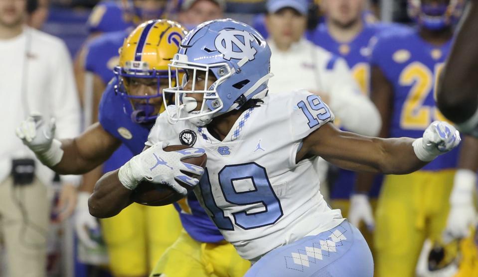 Nov 11, 2021; Pittsburgh, Pennsylvania, USA; North Carolina Tar Heels running back Ty Chandler (19) runs after a catch against the Pittsburgh Panthers during the second quarter at Heinz Field. Mandatory Credit: Charles LeClaire-USA TODAY Sports