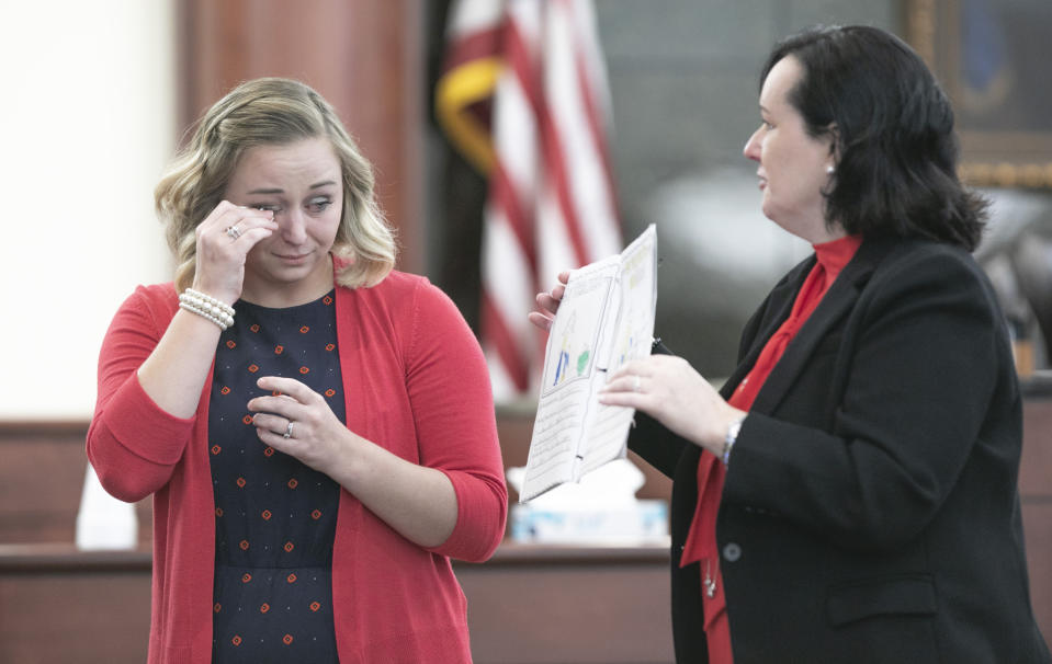 Saxe Gotha Elementary School teacher Jacquelin Moran reads an entry to the jury from Elias Jones' school book with 11th Circuit deputy Solicitor Suzanne Mayes during the sentencing phase of the trial of Tim Jones in Lexington, S.C. on Friday, June 7, 2019. Jones, was found guilty of killing his 5 young children in 2014. (Tracy Glantz/The State via AP, Pool)