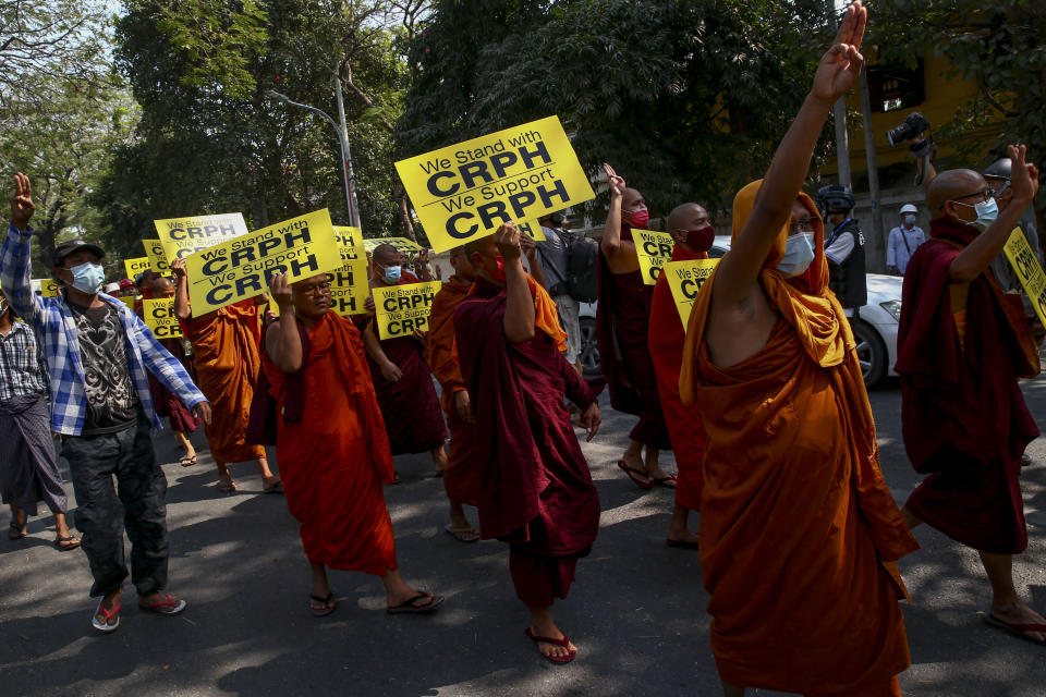 Buddhist monks lead an anti-coup protest march in Mandalay, Myanmar, Saturday, Feb. 27, 2021. Myanmar security forces cracked down on anti-coup protesters in the country's second-largest city Mandalay on Friday, injuring at least three people, two of whom were shot in the chest by rubber bullets and another who suffered a wound on his leg. "CRPH" in the placards stand for "Committee Representing Pyidaungsu Hluttaw." (AP Photo)