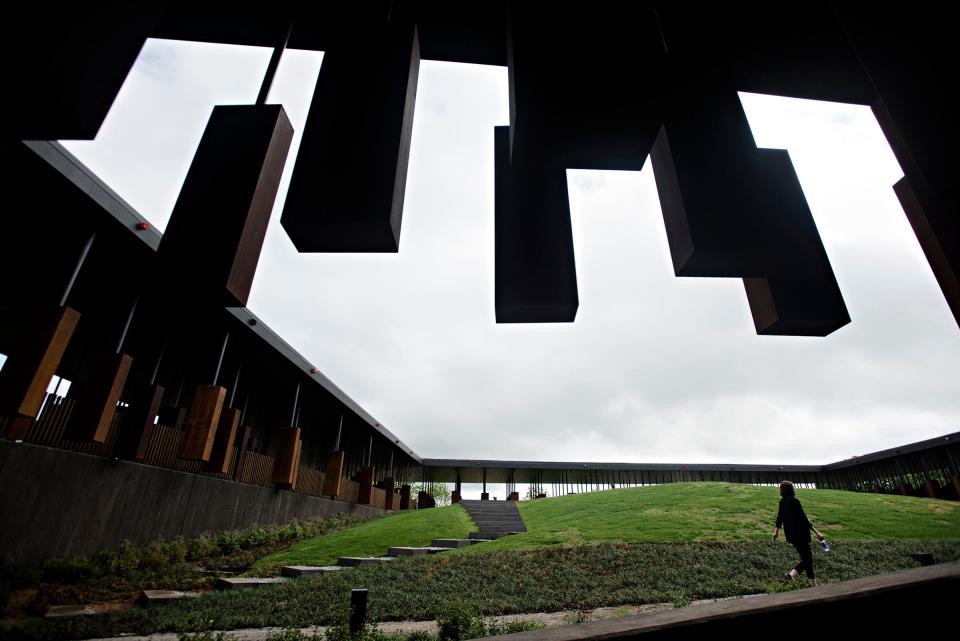 A pedestrian walks through the National Memorial for Peace and Justice on April 23, 2018 in Montgomery, Ala. Each column is a monument to lynching victims in different counties throughout the United States. The memorial is a project of the nonprofit Equal Justice Initiative. It is scheduled to open to the public on Thursday, April 26, 2018. 