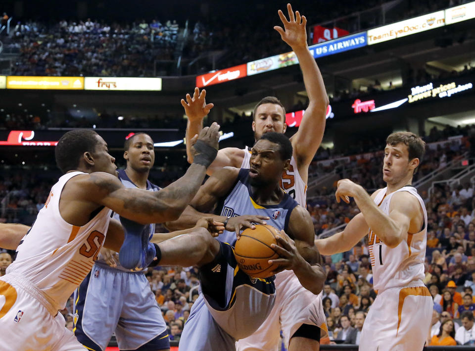 Memphis Grizzlies' Tony Allen, center, is pressured by Phoenix Suns' Eric Bledsoe, left, Miles Plumlee, rear, and Goran Dragic, of Slovenia, during the first half of an NBA basketball game, Monday, April 14, 2014, in Phoenix. (AP Photo/Matt York)