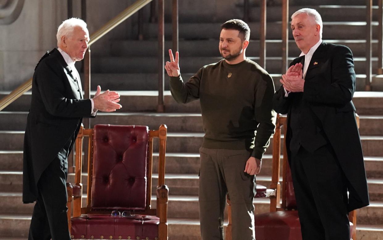 Volodymyr Zelensky raises his right hand in the V for Victory pose - Stefan Rousseau/PA