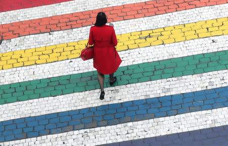 A woman crosses a road outside the EU Parliament ahead of the EU elections in Brussels, Belgium, May 22, 2019. REUTERS/Yves Herman TPX IMAGES OF THE DAY