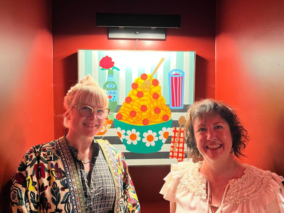 Memphis artist Stacy Kiehl and Cocozza Italian American owner Deni Reilly in front of Kiehl's painting "That's Amore."