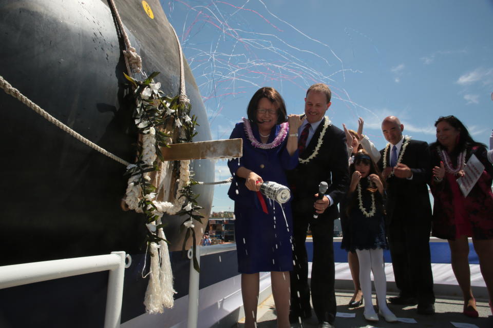 This photo provided by Bath Iron Works shows Irene Hirano Inouye smiles after breaking a bottle of Champagne on the bow of a warship bearing the name of her late husband, Hawaii Sen. Daniel Inouye, during a ceremony at Bath Iron Works on Saturday, June 22, 2018, in Bath, Maine. (Dennis Griggs/Bath Iron Works via AP)