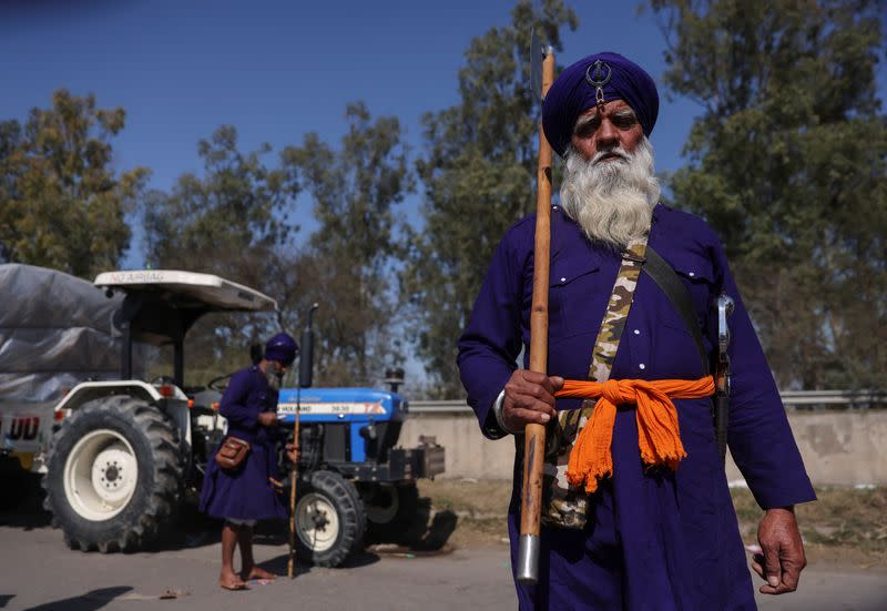 A nihang or Sikh warrior stands at a protest site where farmers are marching towards New Delhi to press for the better crop prices promised to them in 2021, at Shambhu Barrier