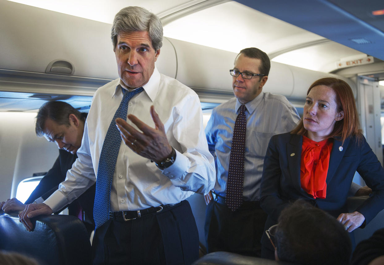 State Department spokesperson Jen Psaki, right, with then-Secretary of State John Kerry, en route to Beijing