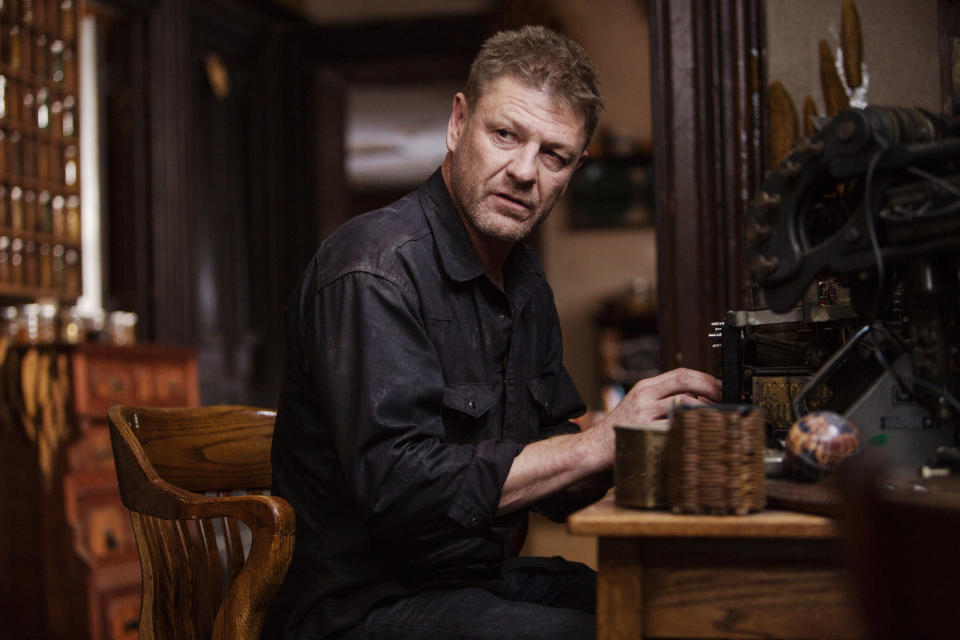 Sean in the film sitting at a desk