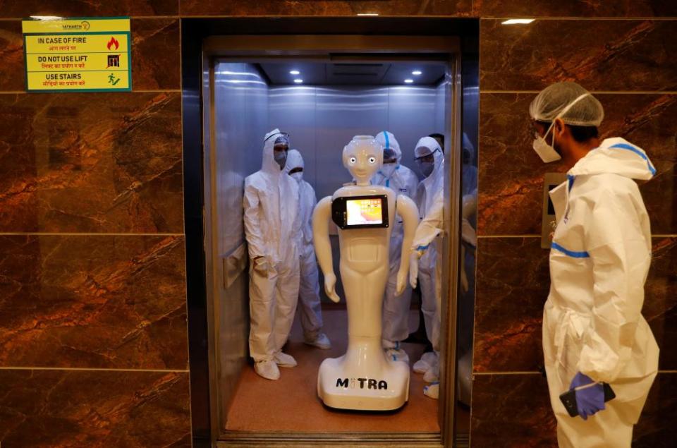 Mitra shares a lift in a hospital in Noida. The robot is being used to treat Covid patients.