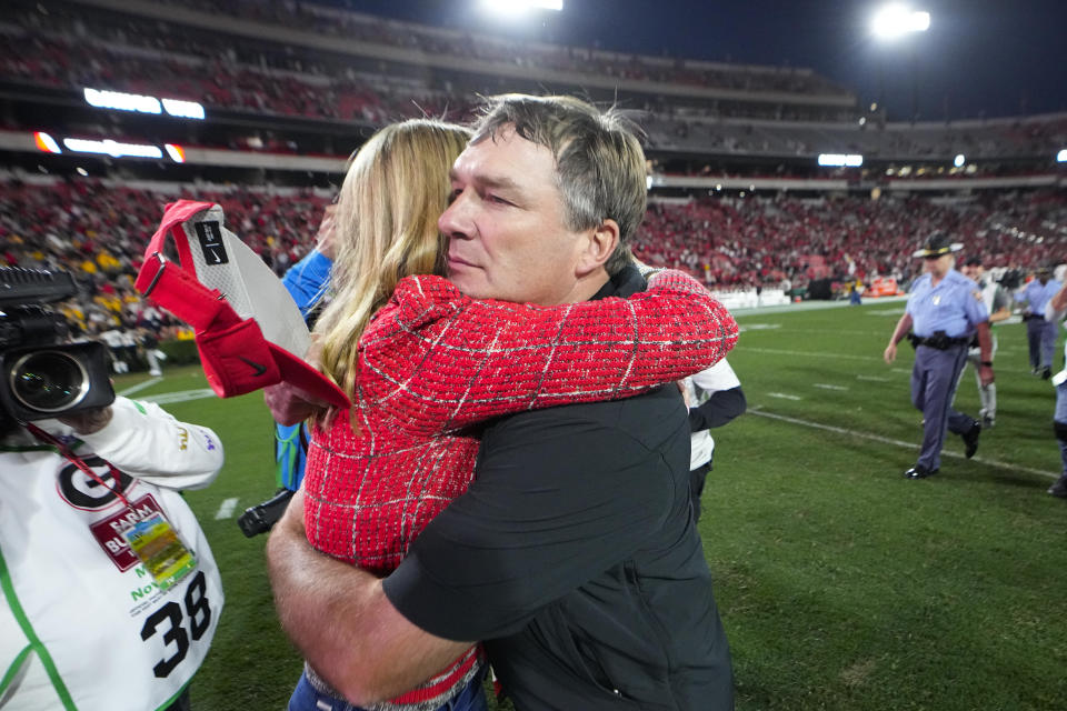 Georgia head coach Kirby Smart hugs his wife Mary Beth Smart after defeating Missouri in an NCAA college football game, Saturday, Nov. 4, 2023, in Athens, Ga. (AP Photo/John Bazemore)